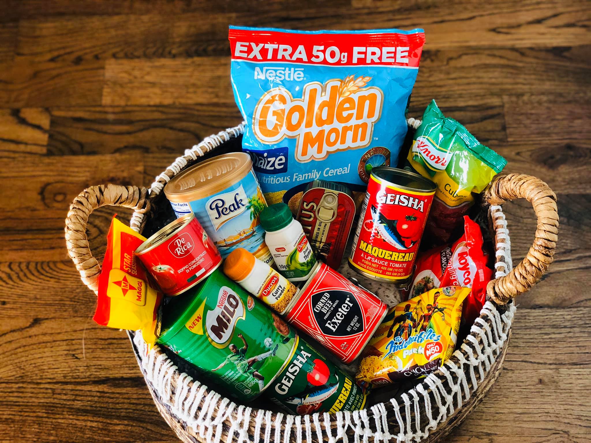 Basket of authentic Nigerian groceries — Obiji palm oil, beans flour, okpa flour, dried ugu leaves, mixed spice